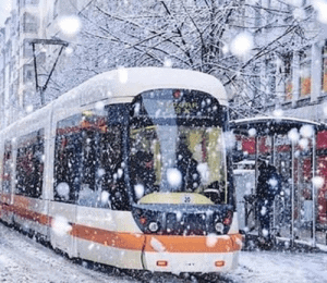 Modern tram in Eskişehir running through snow-covered streets during winter