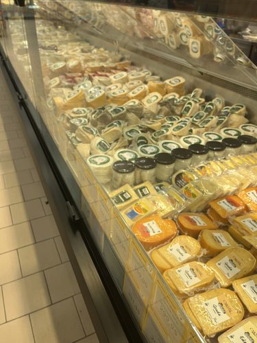 Refrigerated display case at Özdilek Supermarket in Eskişehir, filled with a wide variety of cheeses including wheels of Turkish Kaşar and imported Gouda.